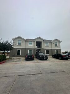 La Joya Apartments Exterior View with Parked Cars