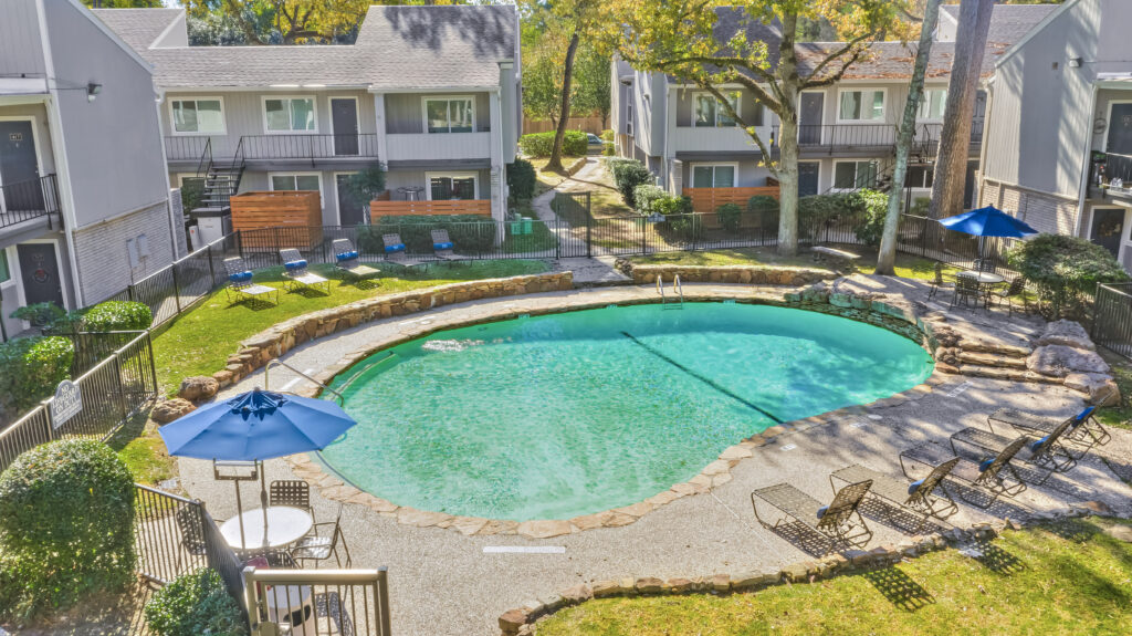 Trailwood Village Apartments' Exterior with Swimming Pool and other Amenities View